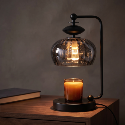 Black candle warmer lamp with smoky glass shade displayed in a warm modern interior