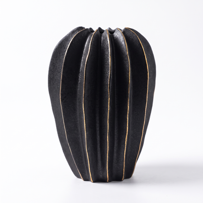 Black ribbed carambola ceramic vase on a white background