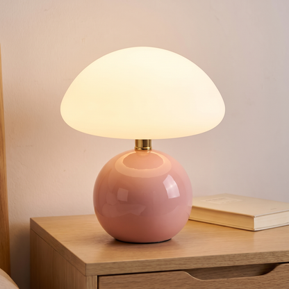 Blush ceramic mushroom lamp with glass dome displayed in a warm modern interior