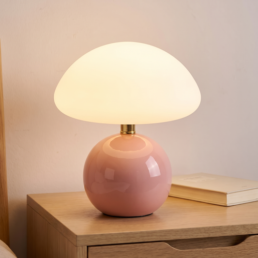 Blush ceramic mushroom lamp with glass dome displayed in a warm modern interior