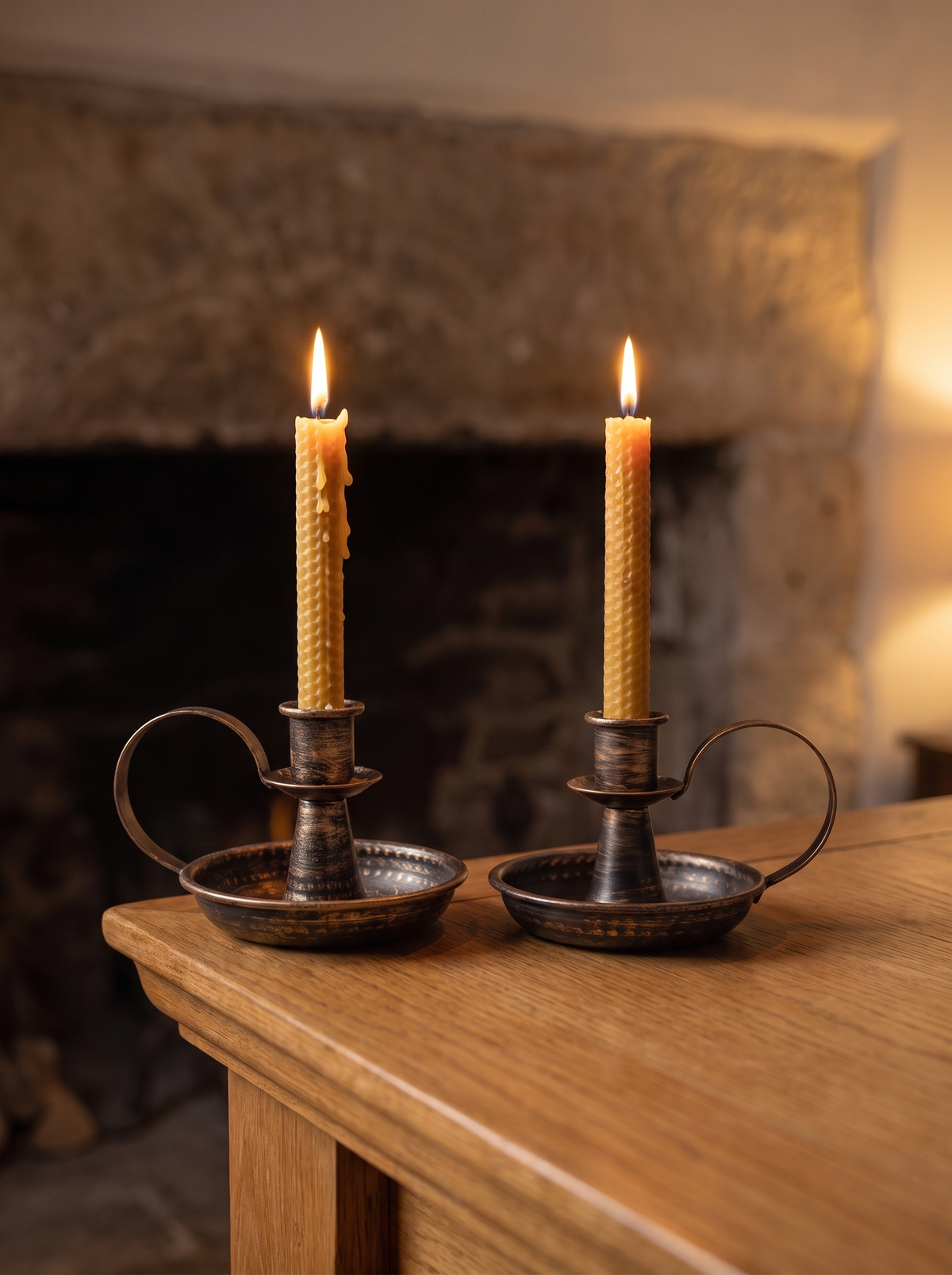 Pair of iron candle holders on a mantel