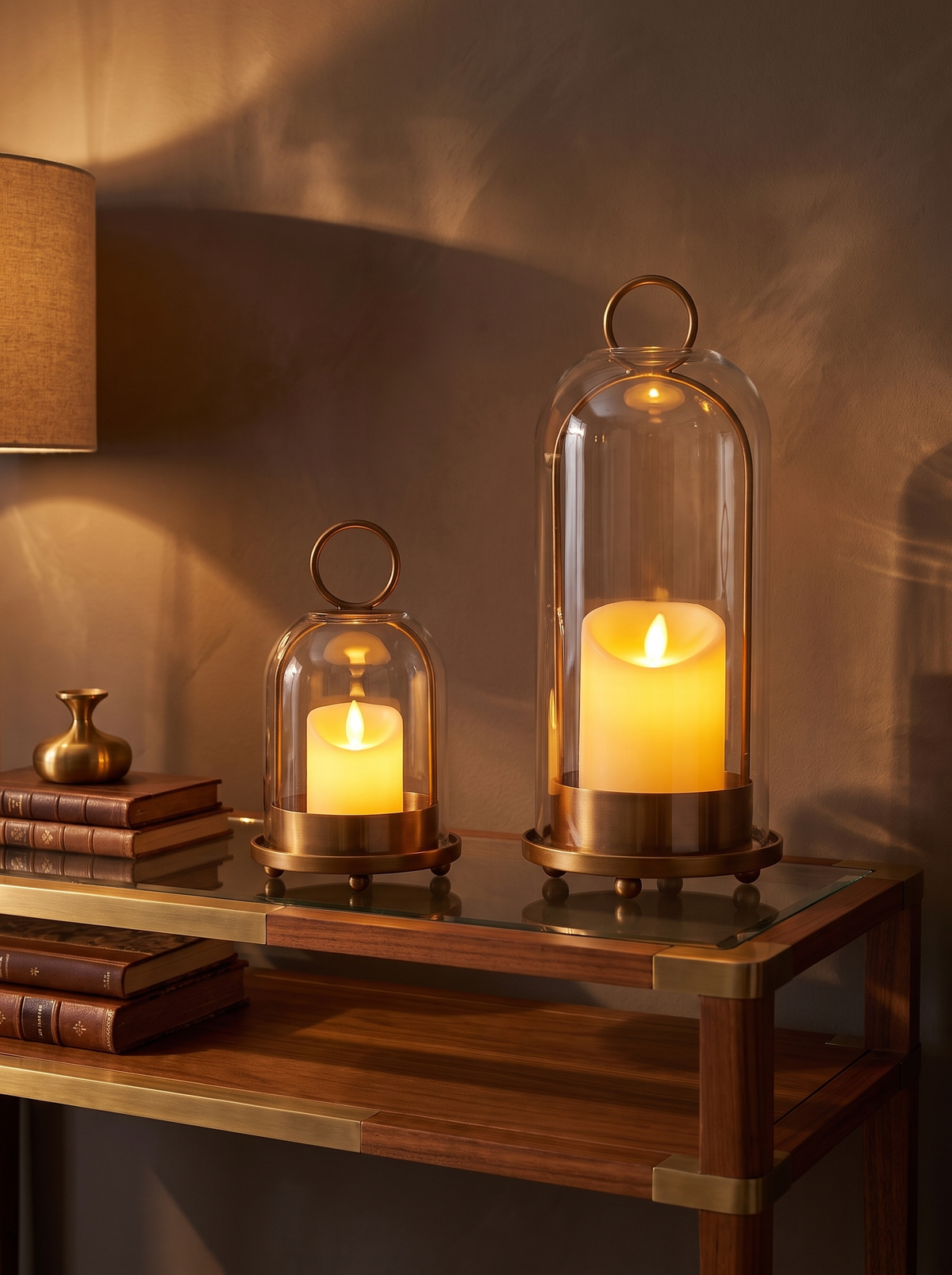 Brass candle stand with glass dome on a console