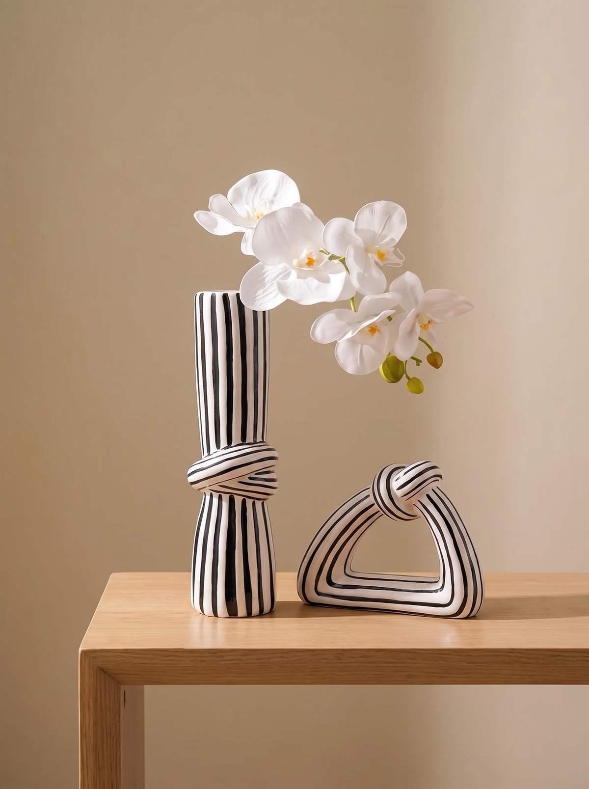 Striped ceramic knot vase on a minimalist console