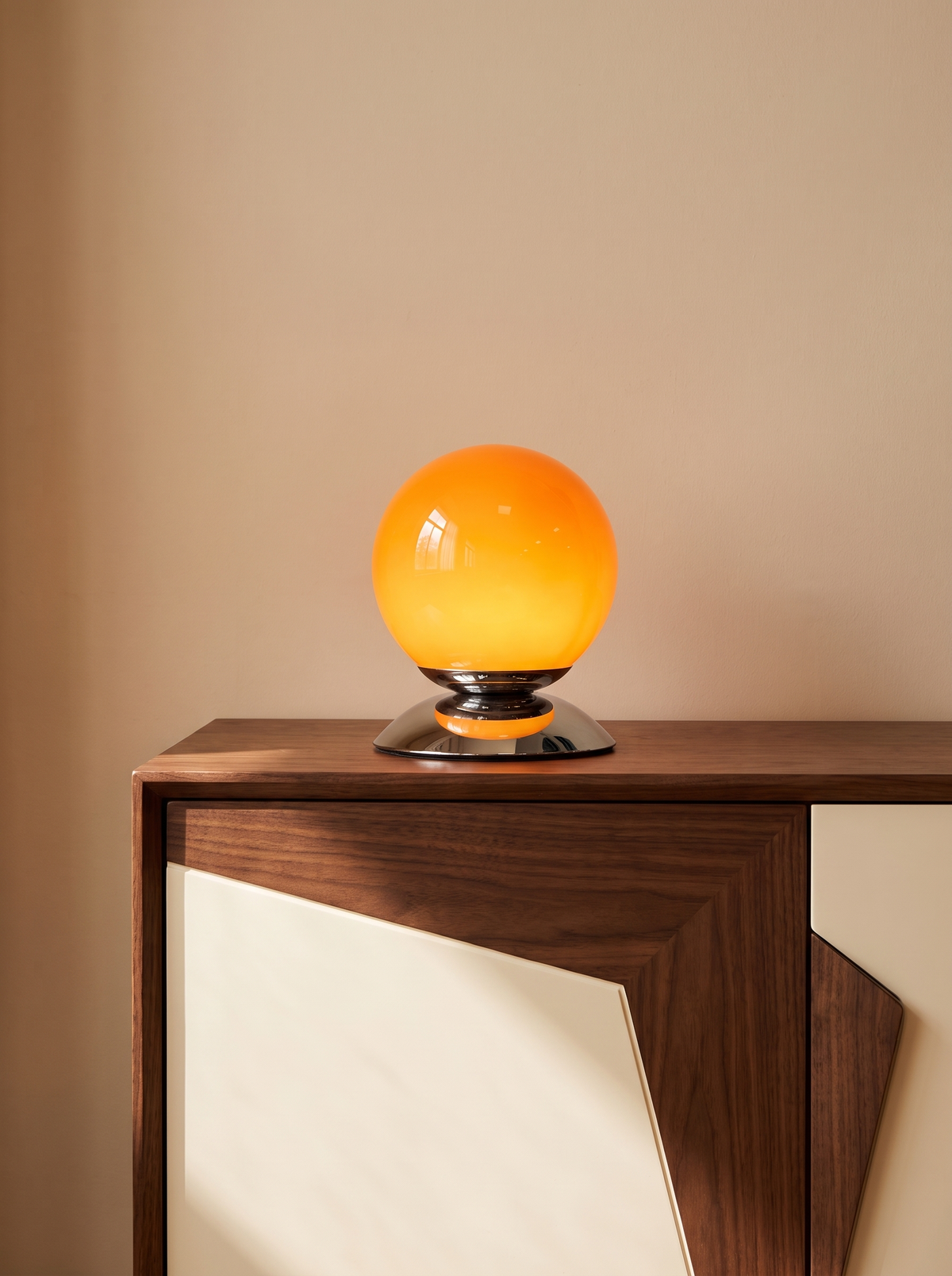 Glass globe lamp on a geometric sideboard