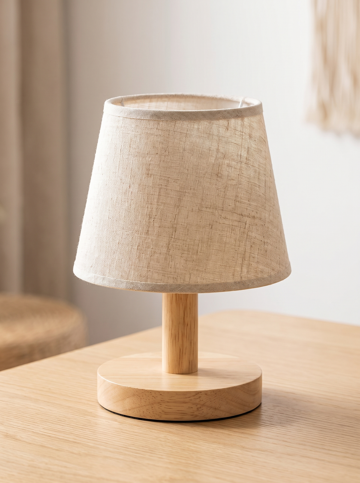 Close view of a wooden lamp base and linen shade
