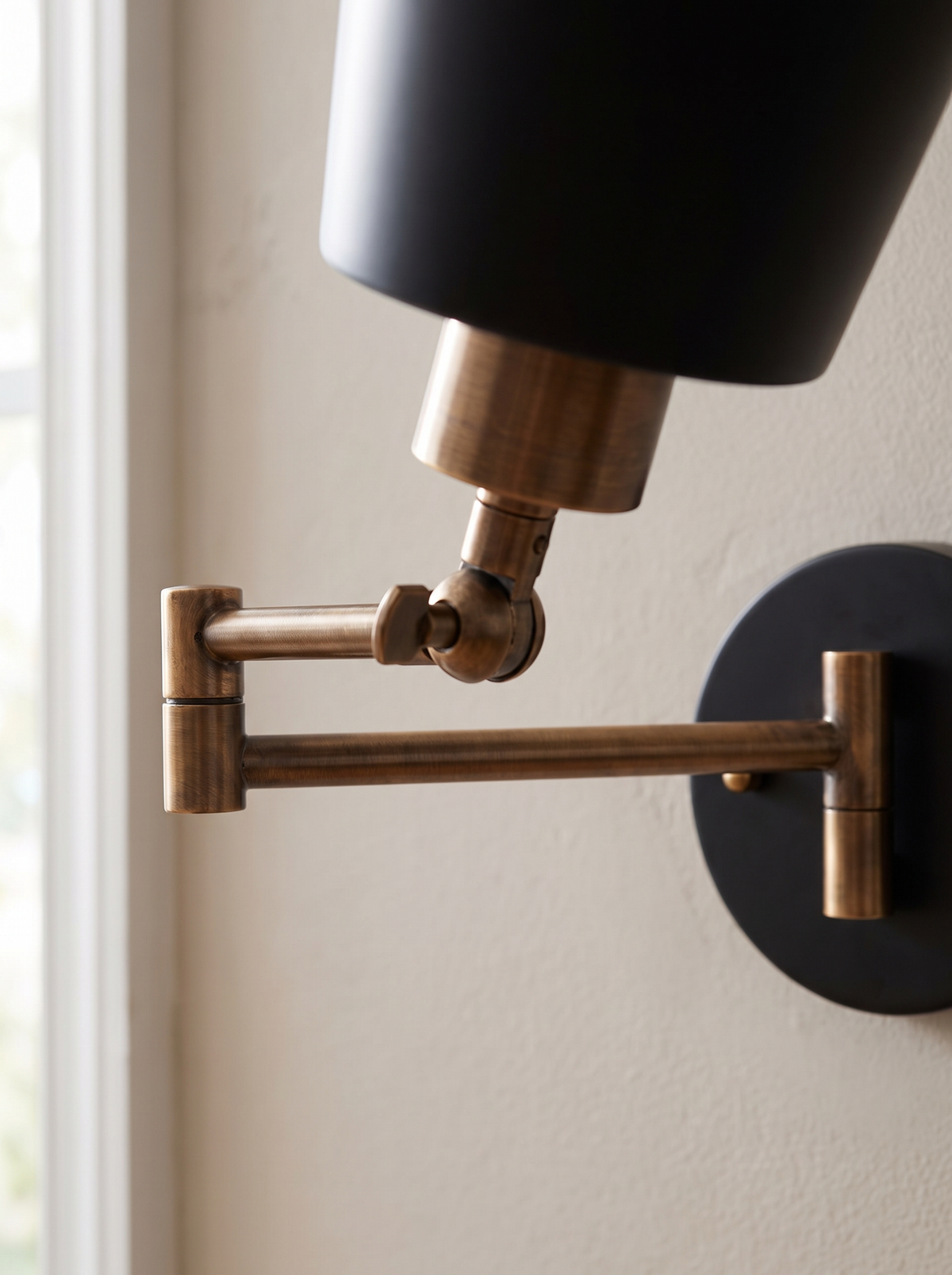 Close view of a bronze swing arm and pivot joint