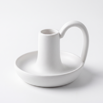 Minimal ceramic taper candle holder with handle on a white background
