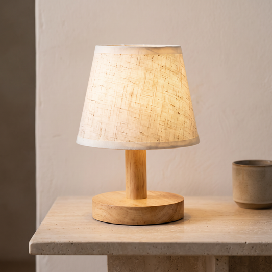 Minimalist wooden table lamp with linen shade displayed in a warm modern interior