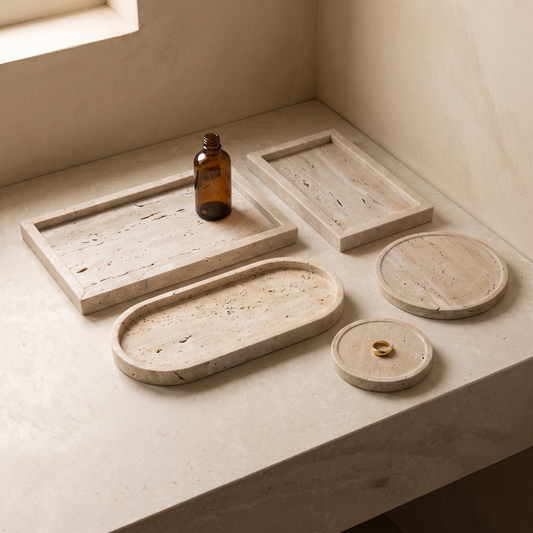 All five natural travertine vanity tray sizes together on a limestone vanity